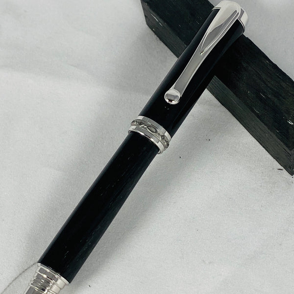 Jr. Statesman Rollerball, finished with rhodium and black titanium. Barrels crafted with 5000 year old Bog Wood